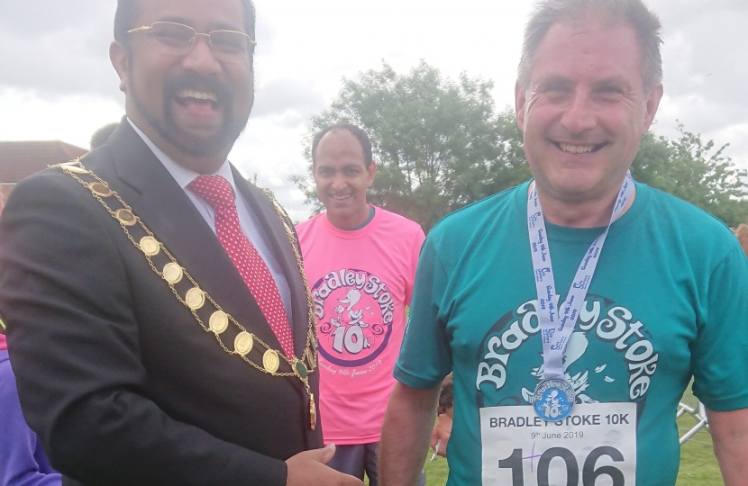 Mayor Tom Aditya presents Jack with his medal