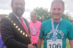 Mayor Tom Aditya presents Jack with his medal