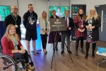 Jack unveiling plaque at new educational facility.