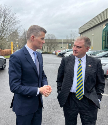 Mark Harper MP and Jack Lopresti MP talking to each other outside DHL in Bradley Stoke.